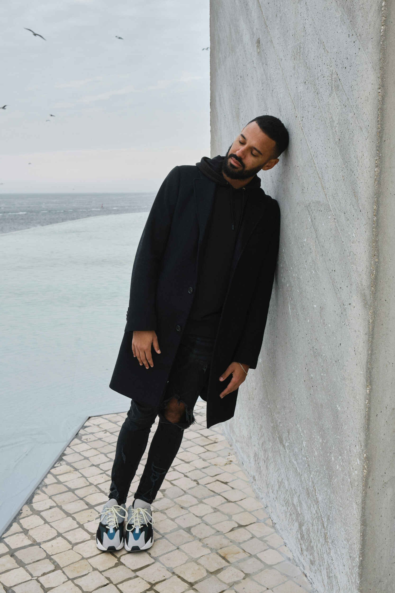 Man outside leaning against a wall - life coach Chandler AZ