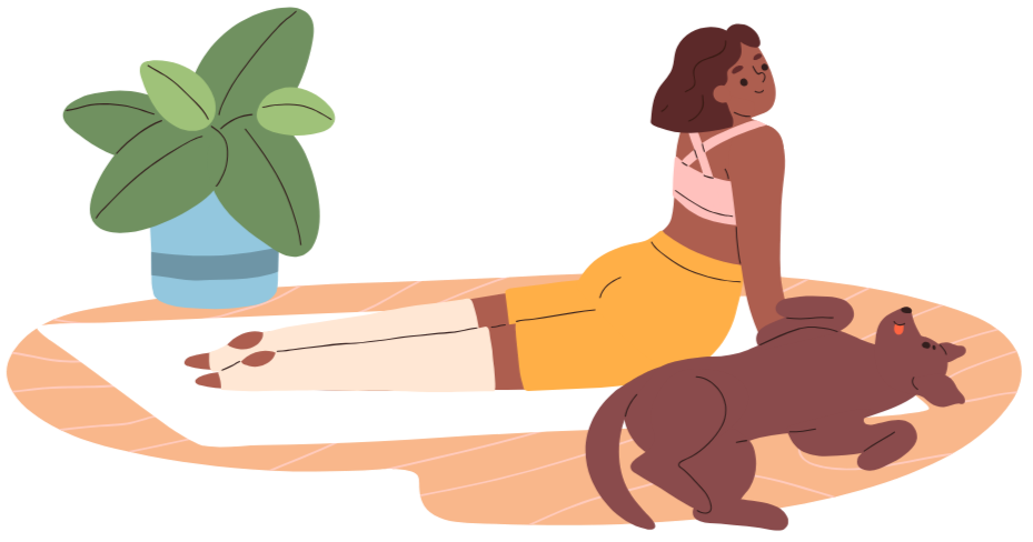 A woman with short brown hair lying on her stomach on a white rug next to a large green potted plant, with two dogs playing nearby.