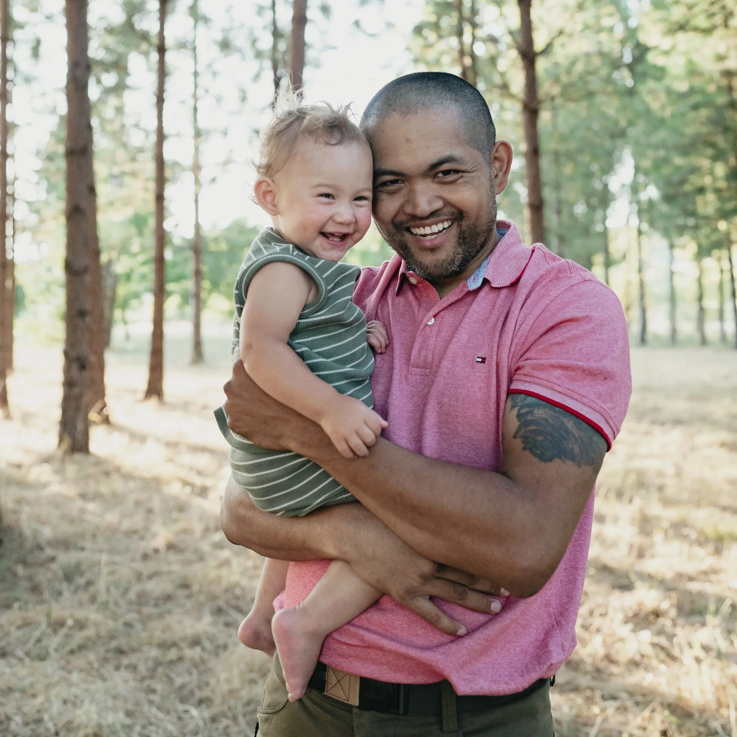 A father gleefully holds his son