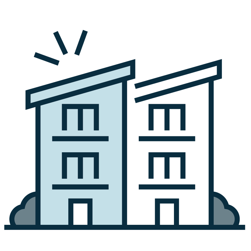 Two apartment buildings with smoke rising from one top window, indicating a fire emergency.