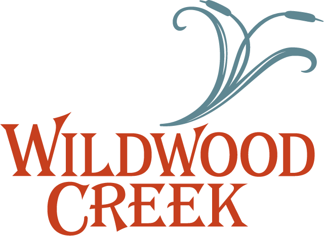 Wildwood Creek logo with stylized floral design above the text.