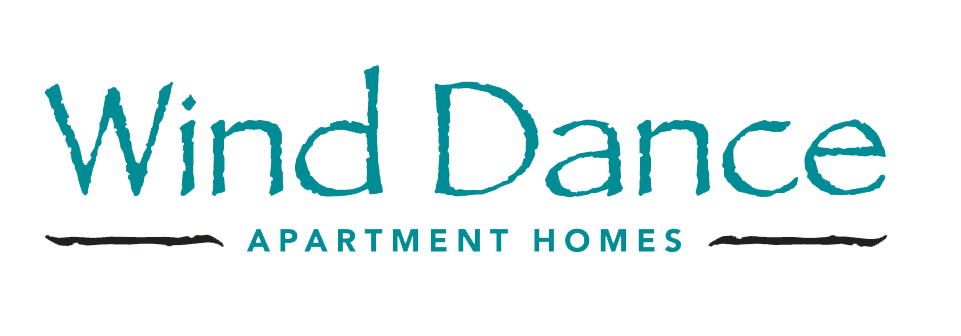 Logo for Wind Dance Apartment Homes with stylized text and decorative lines.