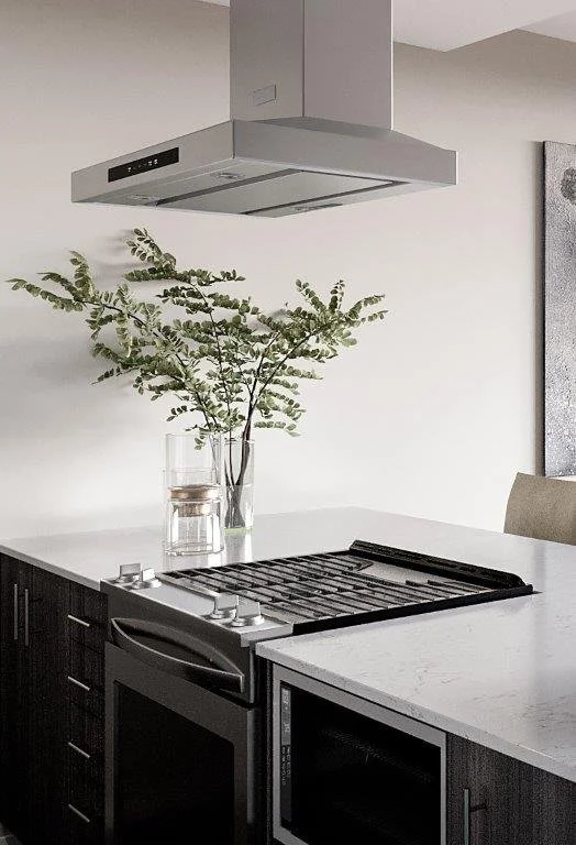 Modern kitchen with a white countertop, black cabinets, and a built-in stove. A glass vase with green leafy branches and a glass of water are on the counter. An air vent is above the stove.