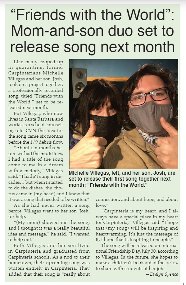 Two people wearing masks, giving thumbs up for a photo in a recording studio.