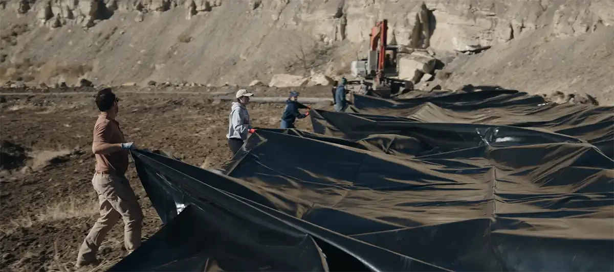 Crew members installing an impermeable methane barrier system at an abandoned coal mine site in Western Colorado