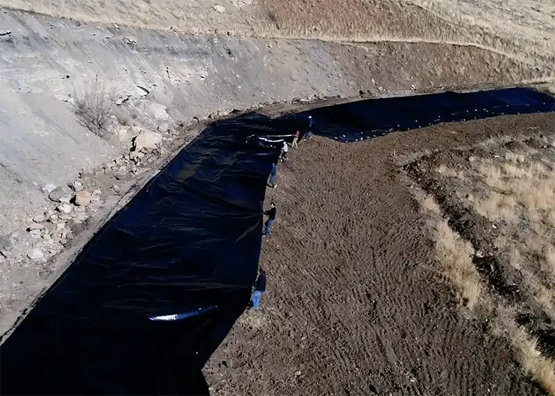 Aerial view of methane containment liner installed over a former coal mine portal to prevent gas leakage.
