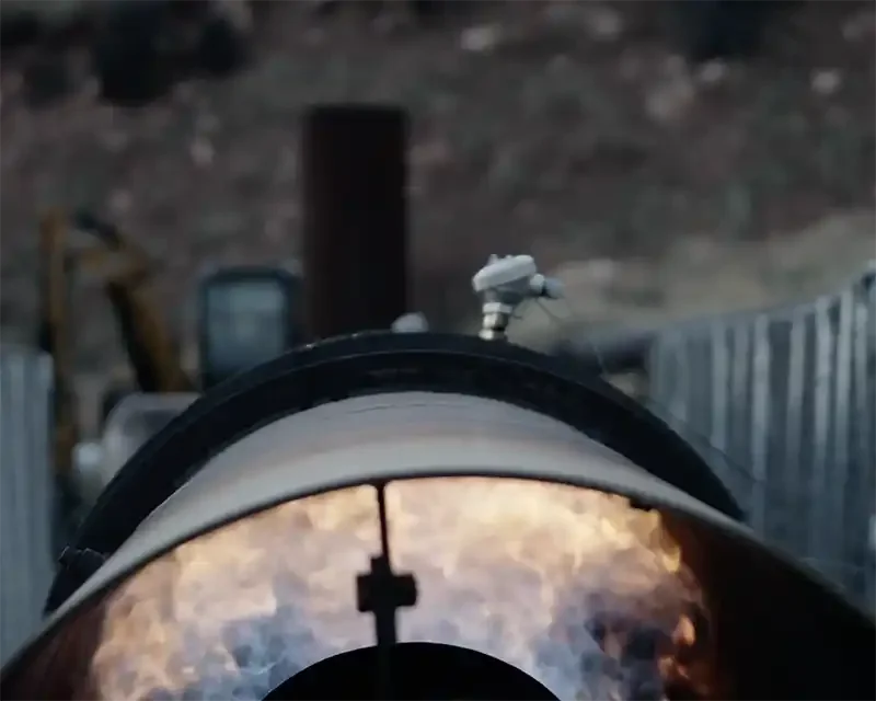 Thermal oxidizer flame system permanently destroying captured methane at an abandoned coal mine site.