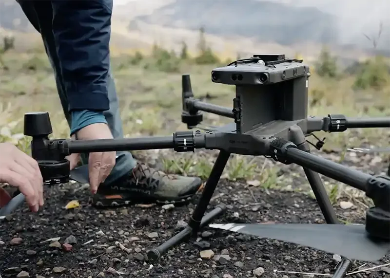 Technician setting up drone-based methane monitoring equipment for emissions measurement and site verification