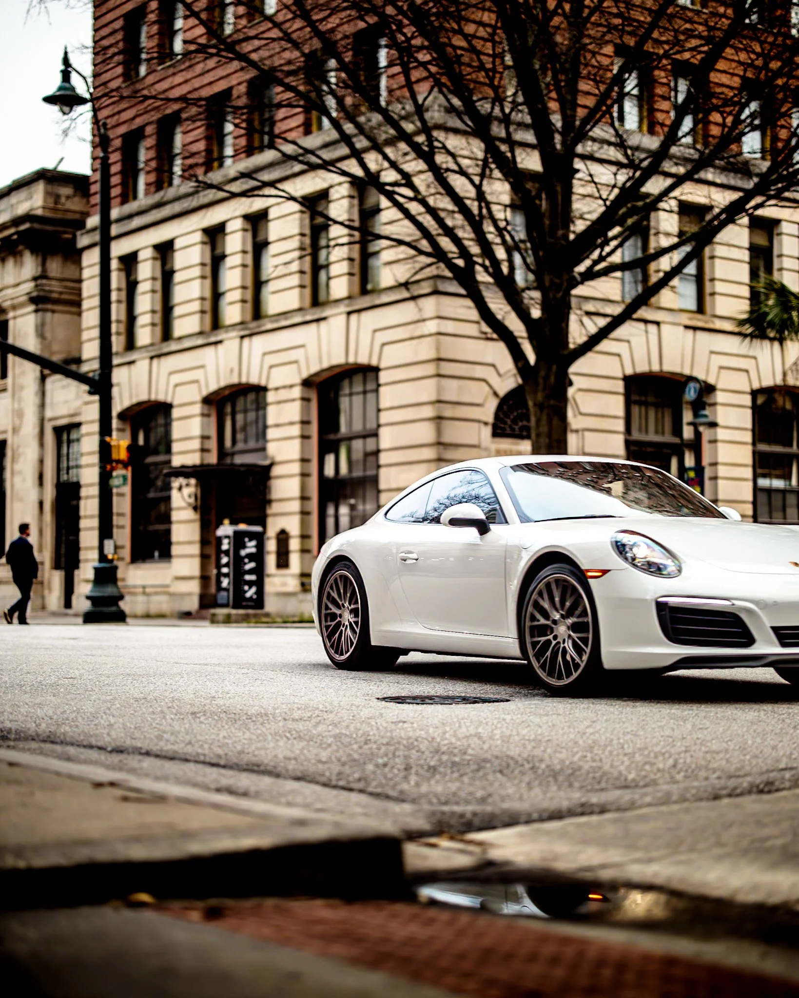 White Porche photographed by Thomas Mangum & MakoCr8s White sports car photographed outside a historic building for automotive and lifestyle brand storytelling