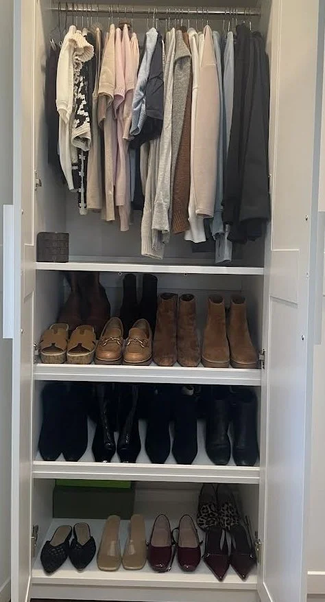 Open closet with hanging clothes, shelves with shoes, boots, and slippers, organized by type.
