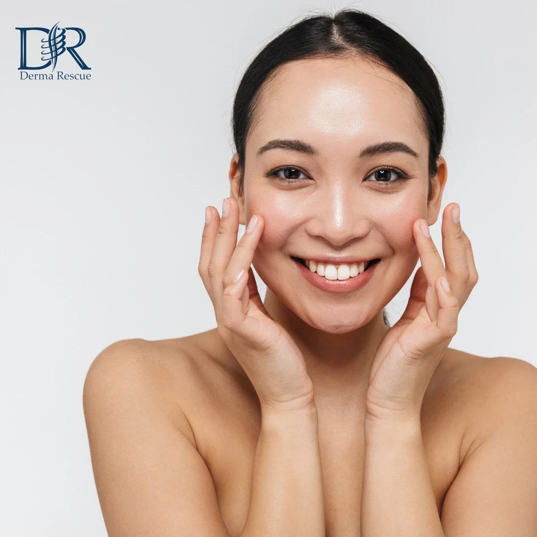 A smiling woman with clear skin holding her face with both hands, against a plain white background. There is a Derma Rescue logo in the top left corner.