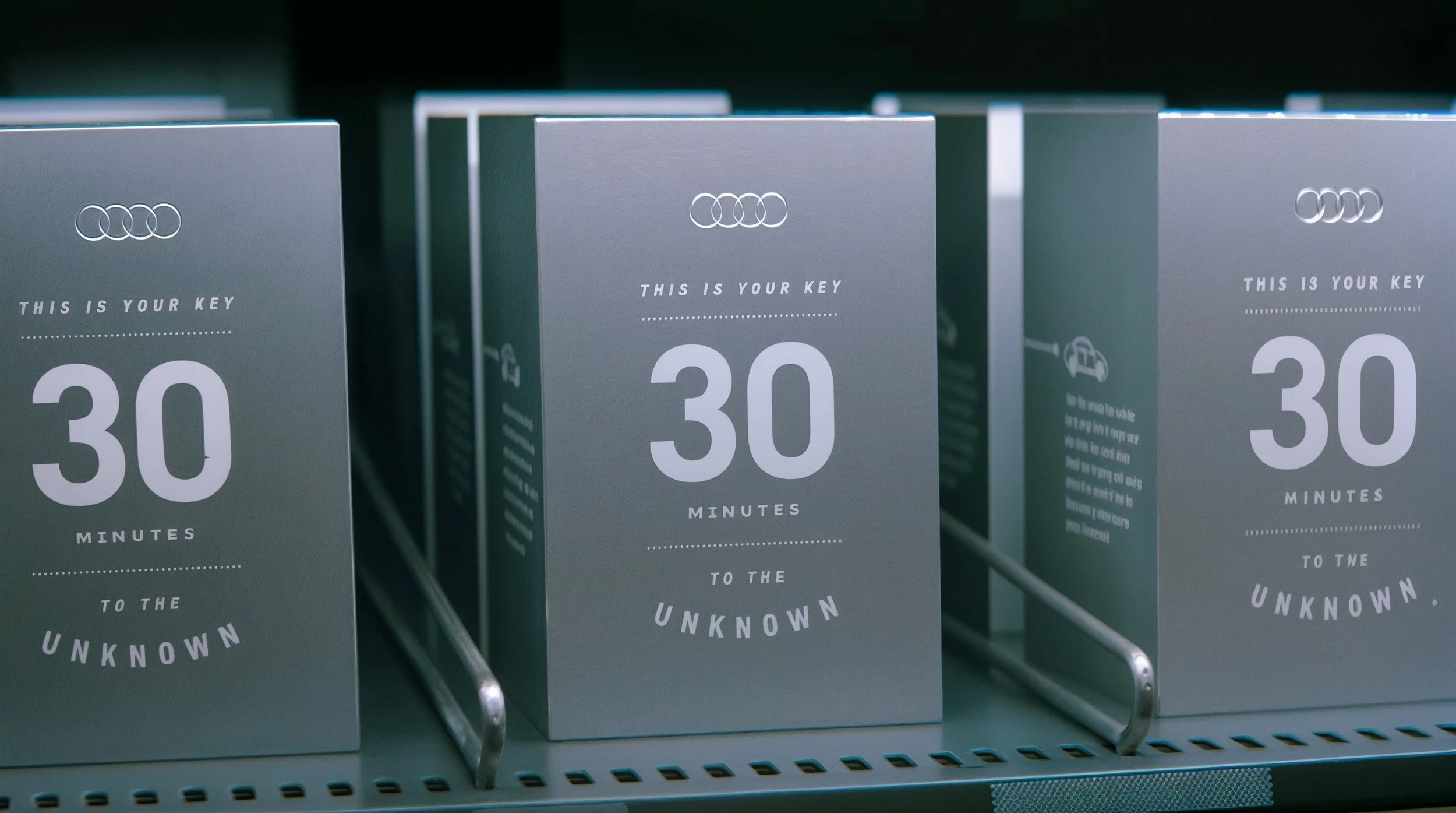 Boxed keycards on a retail shelf with a metallic finish, displaying the number 30 and the words "This is your key, 30 minutes to the unknown."