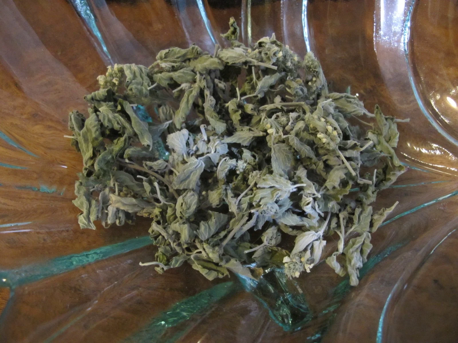 Dried marijuana buds on a glass dish.