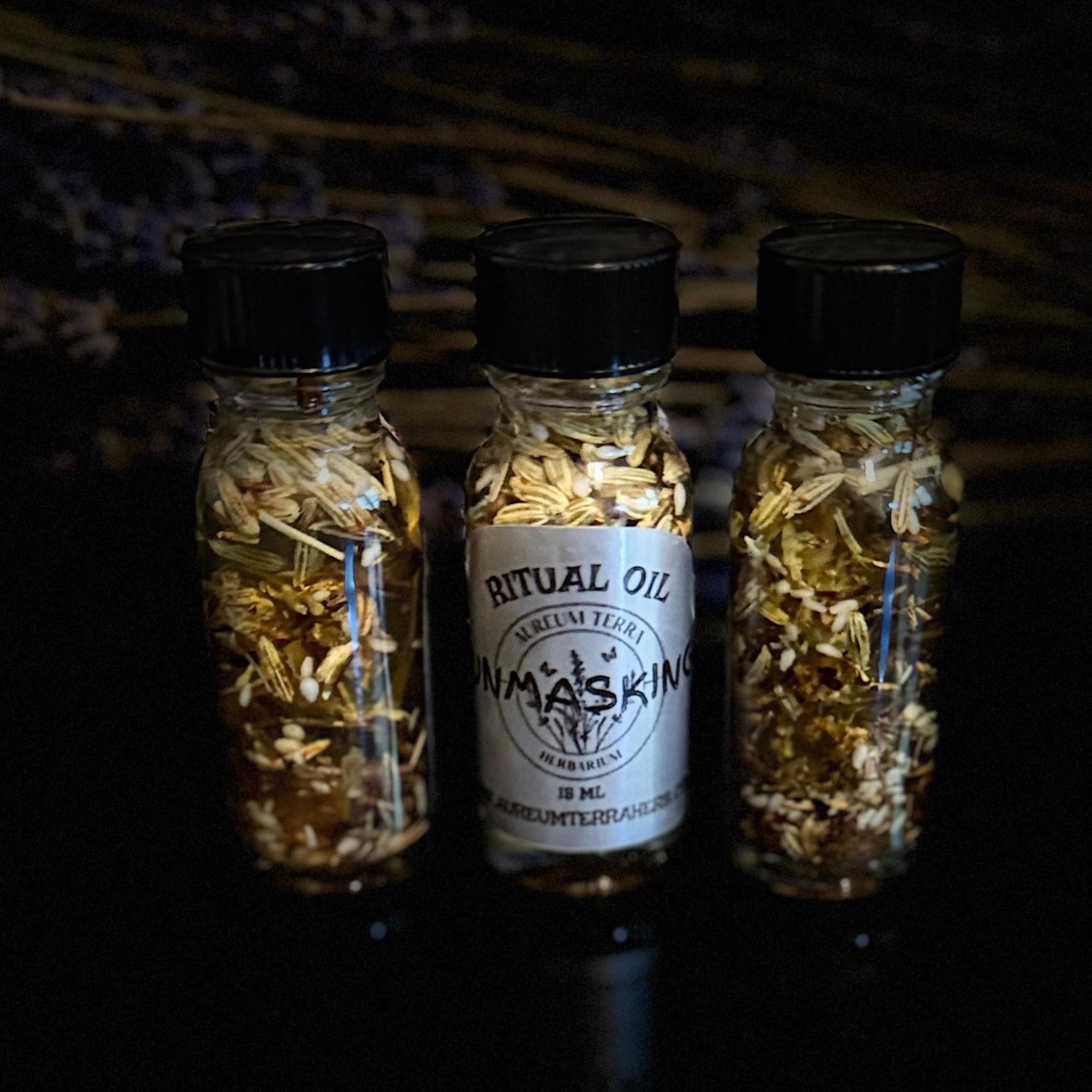 15ml bottle of Unmasking Ritual Intention Oil by Aureum Terra Herbarium for revealing hidden influences and freezing negative energy