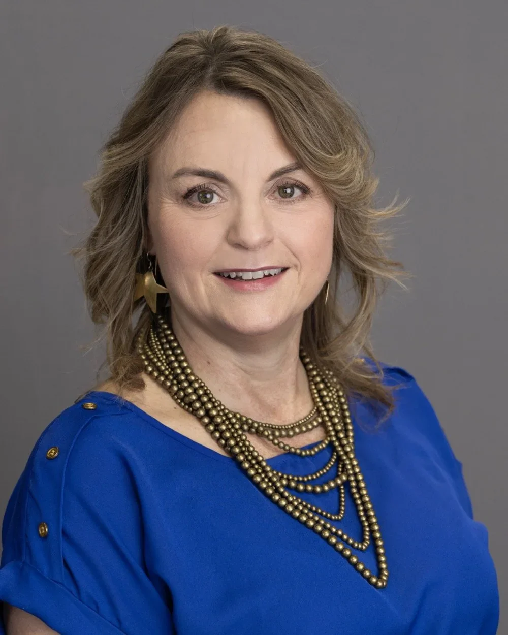 Kelly Edmister, Interior Designer at Seville Home — professional portrait in neutral tones