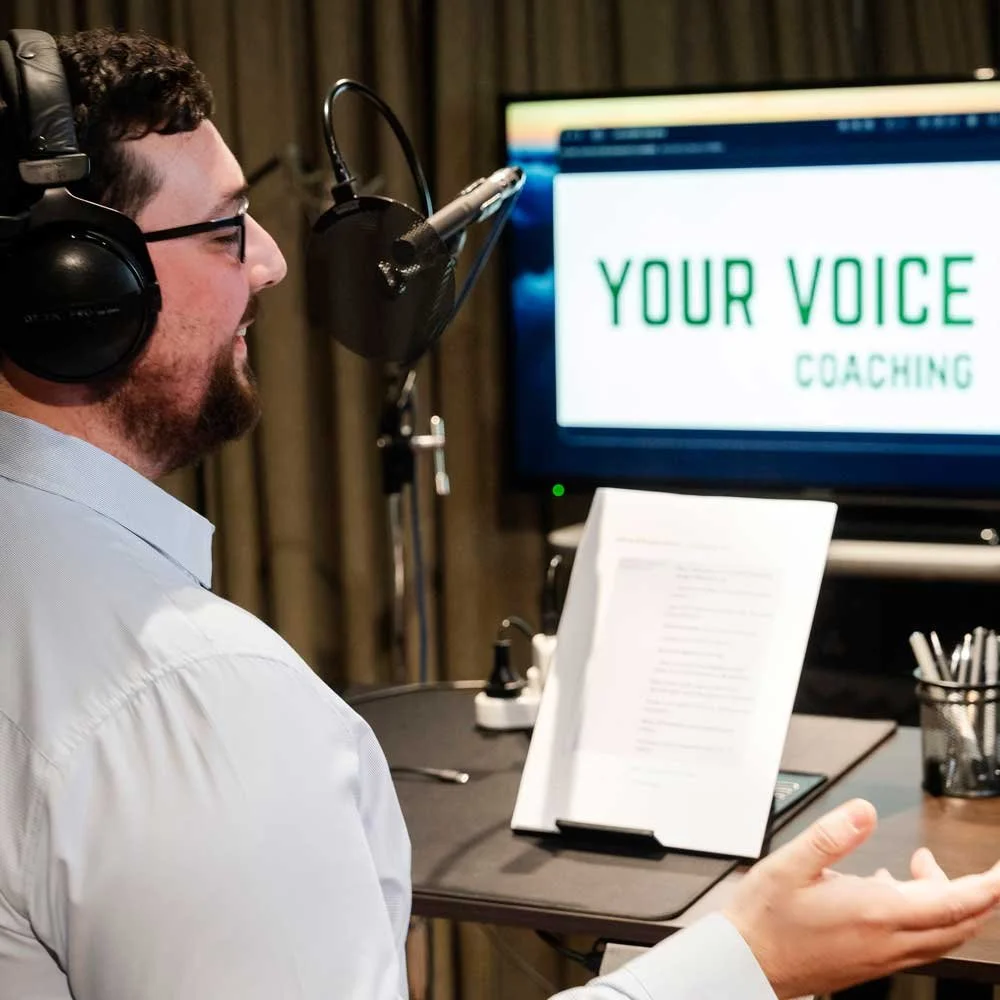 Client receiving one-to-one voice coaching in a professional recording studio.