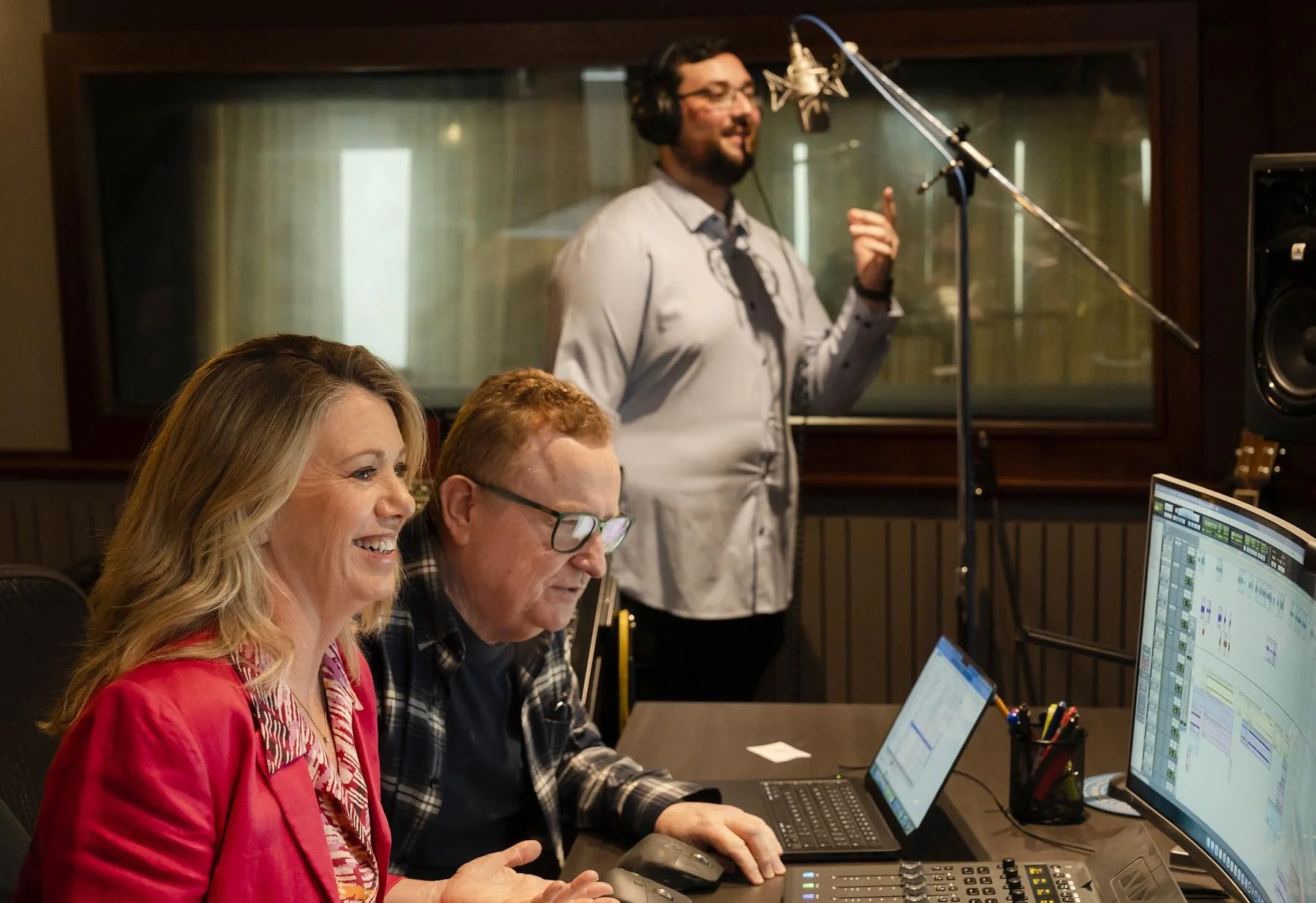 Voice coaching recording session in a professional audio studio.