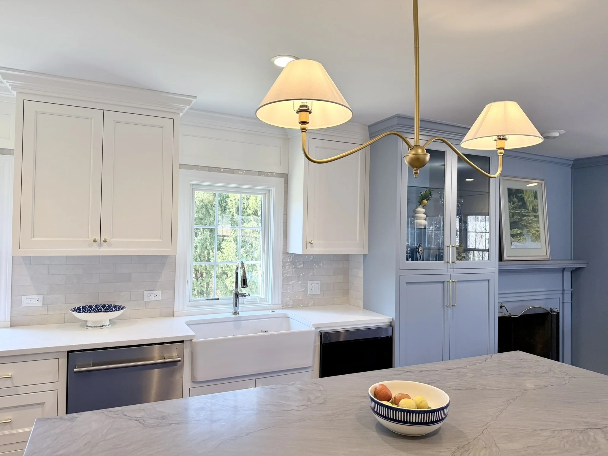 Third Street Interiors (Elmhurst-based interior design firm) featured interior design project of a kitchen remodel in Northfield, IL with gorgeous custom cabinets, contrasting countertops, and fireplace built-ins.