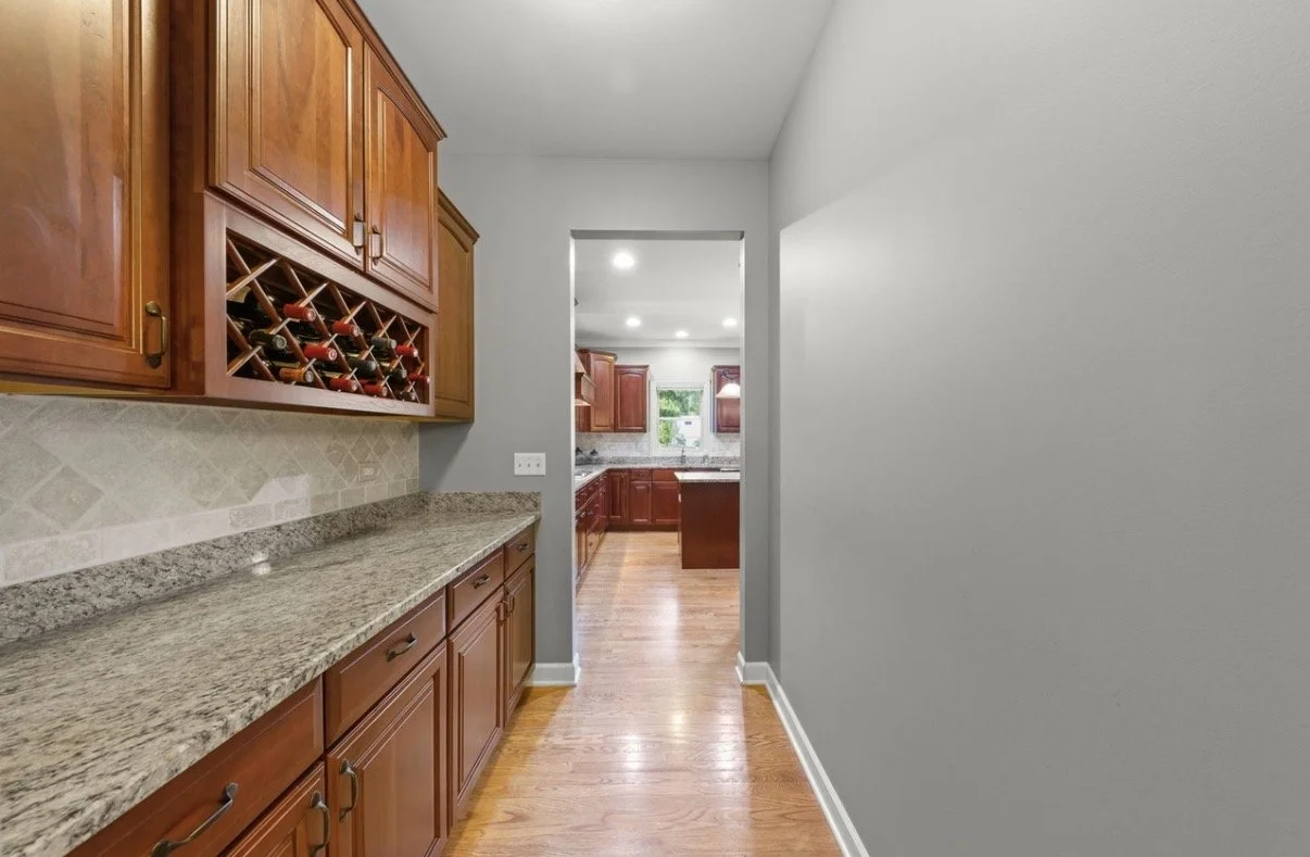 Third Street Interiors (Elmhurst-based interior design firm) featured interior design project of a kitchen refresh in Naperville, IL with painted cabinets, new hardware and light fixtures.