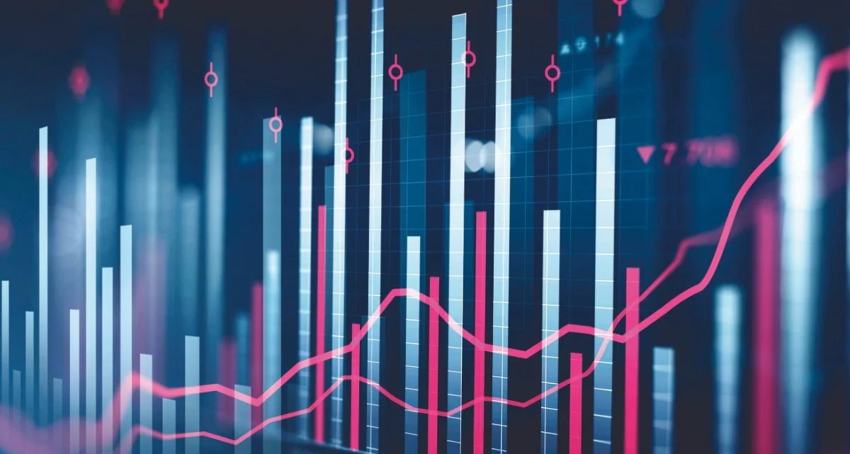Digital financial chart with blue bars and pink line graph indicating data trends.