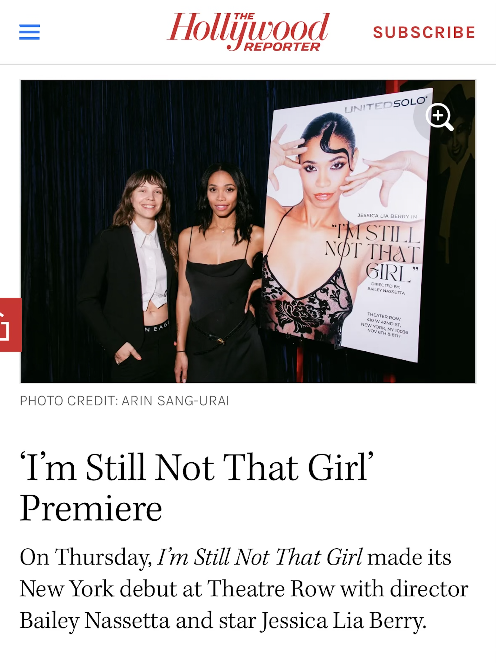 Two women standing next to a promotional poster for the play 'I'm Still Not That Girl' at Theatre Row in New York City.