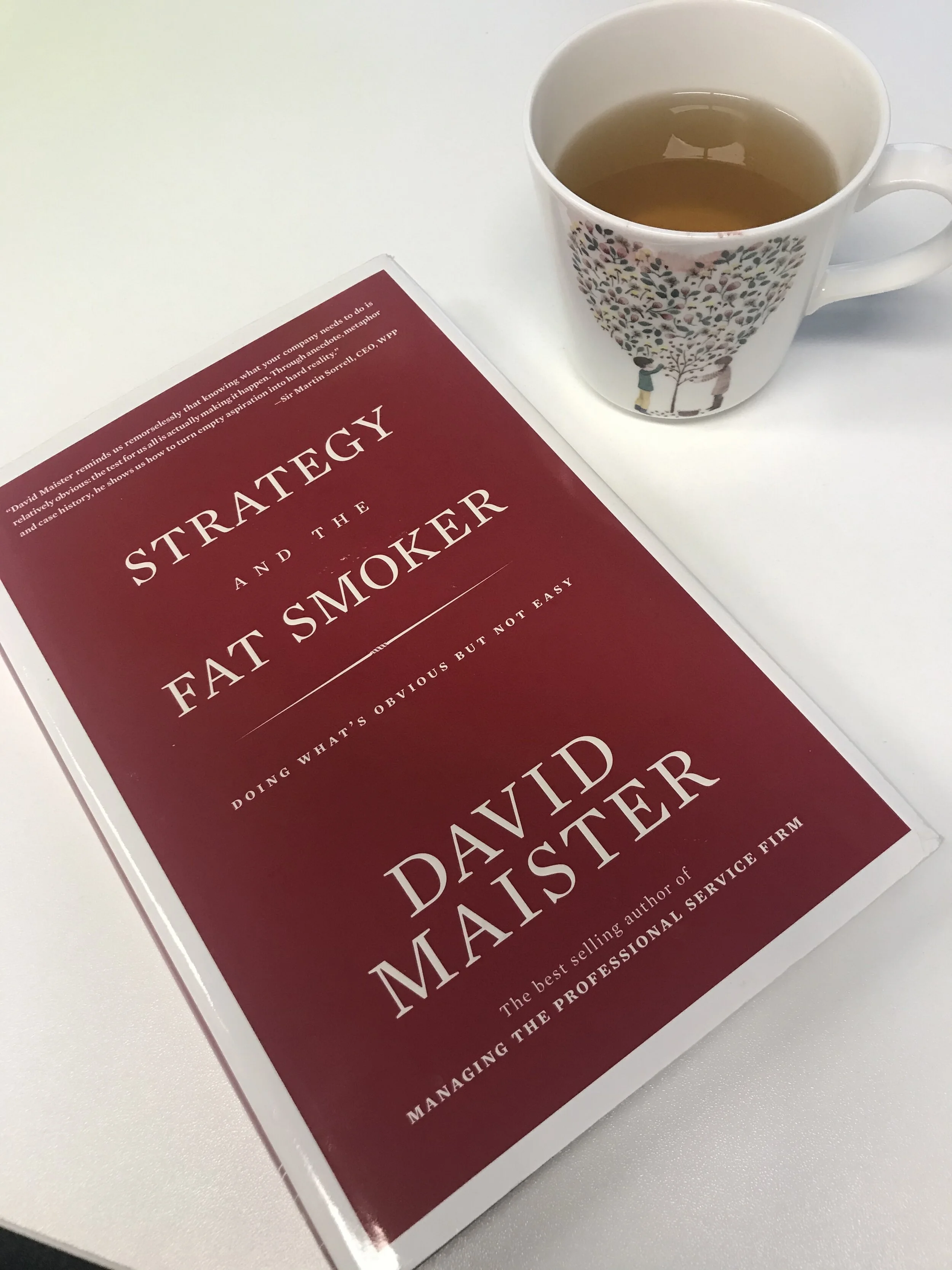 Bright natural dining room nook with vases plates and fruits on the table.