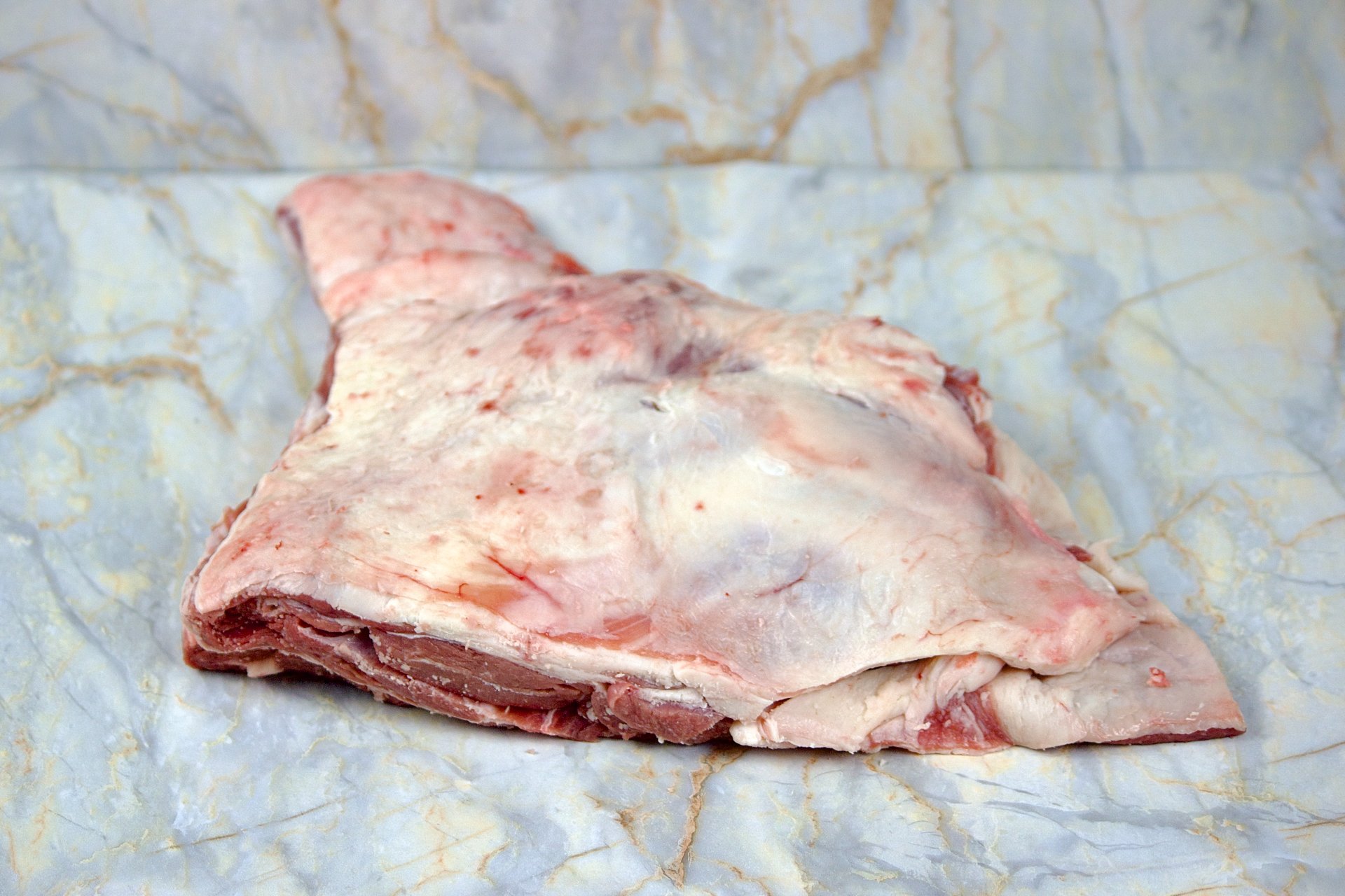 Raw piece of meat on parchment paper