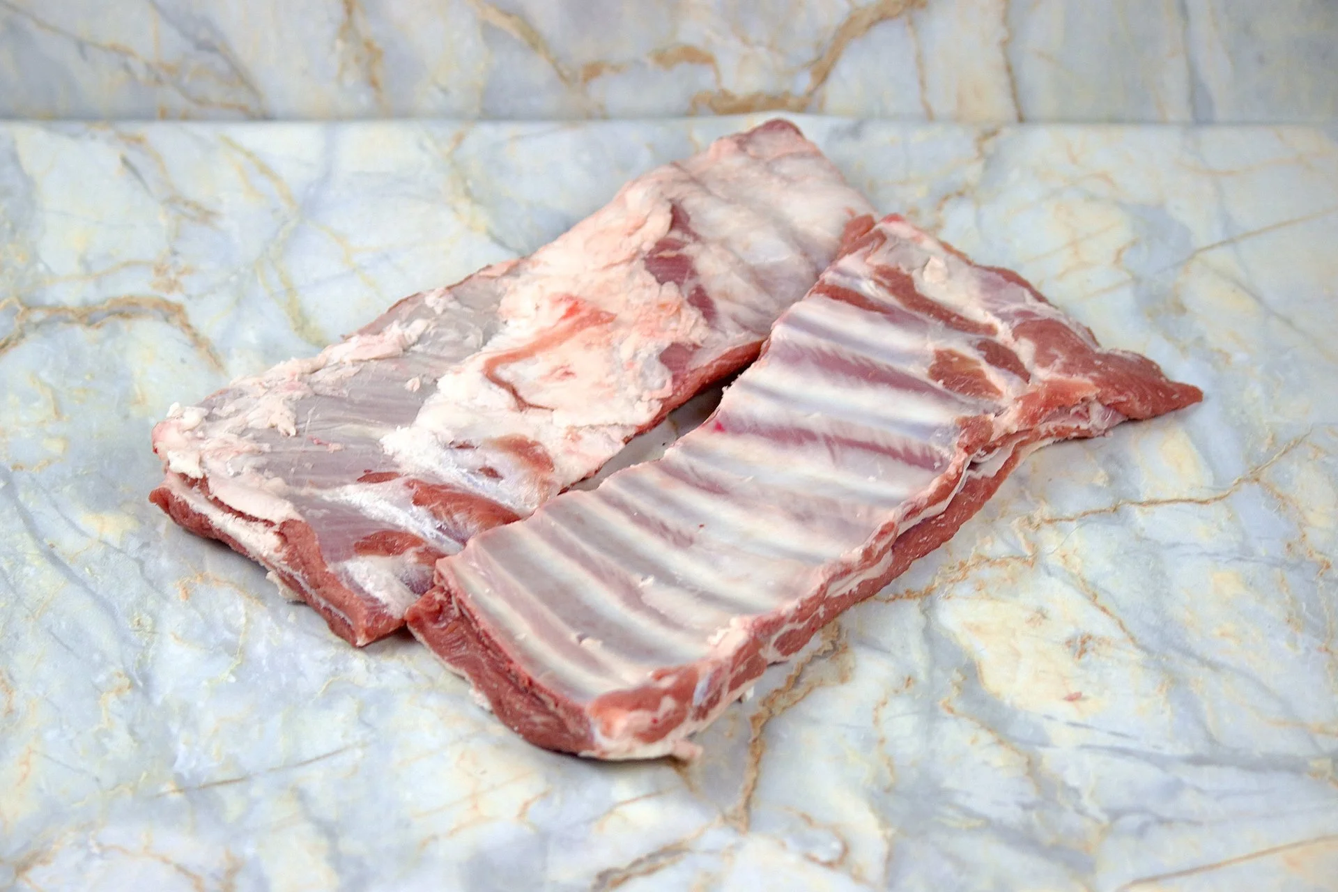 Raw pork ribs on marble surface