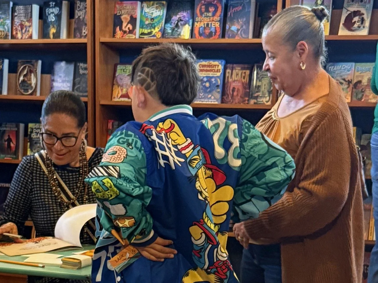Author Gloria Reyes at a book signing at Lark and Owl Georgetown TX