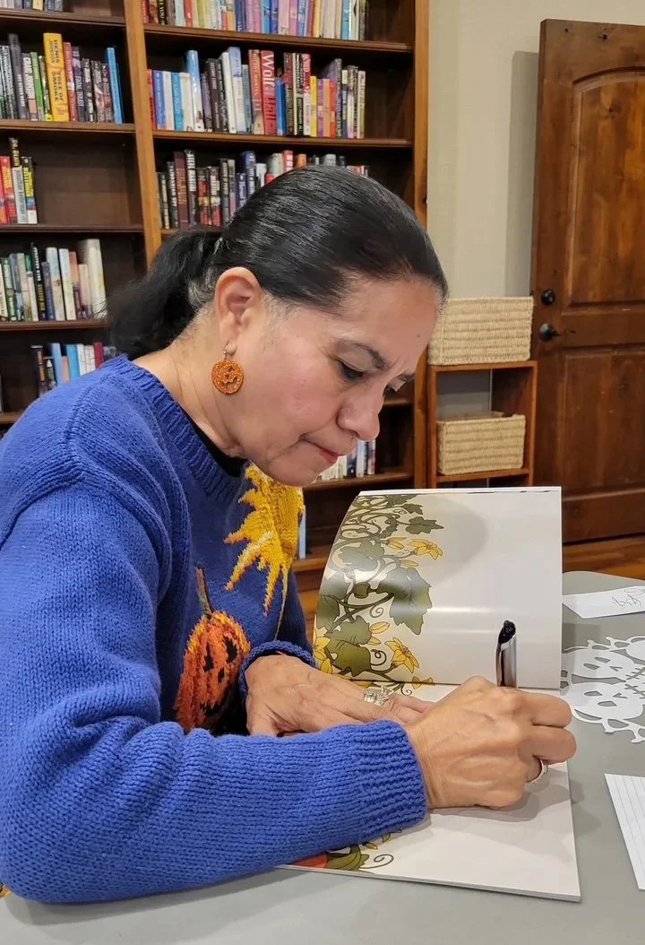 Gloria Reyes signing Joyful Pumpkin book