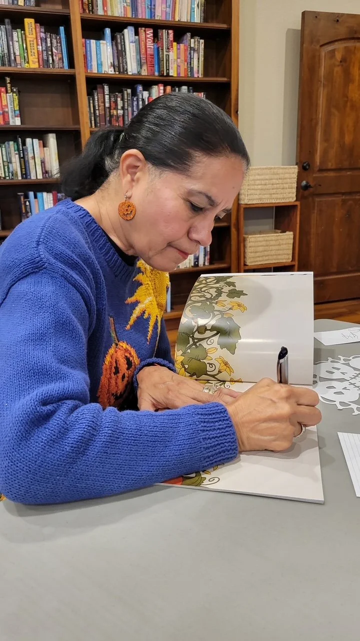 Gloria Reyes signing Joyful Pumpkin book