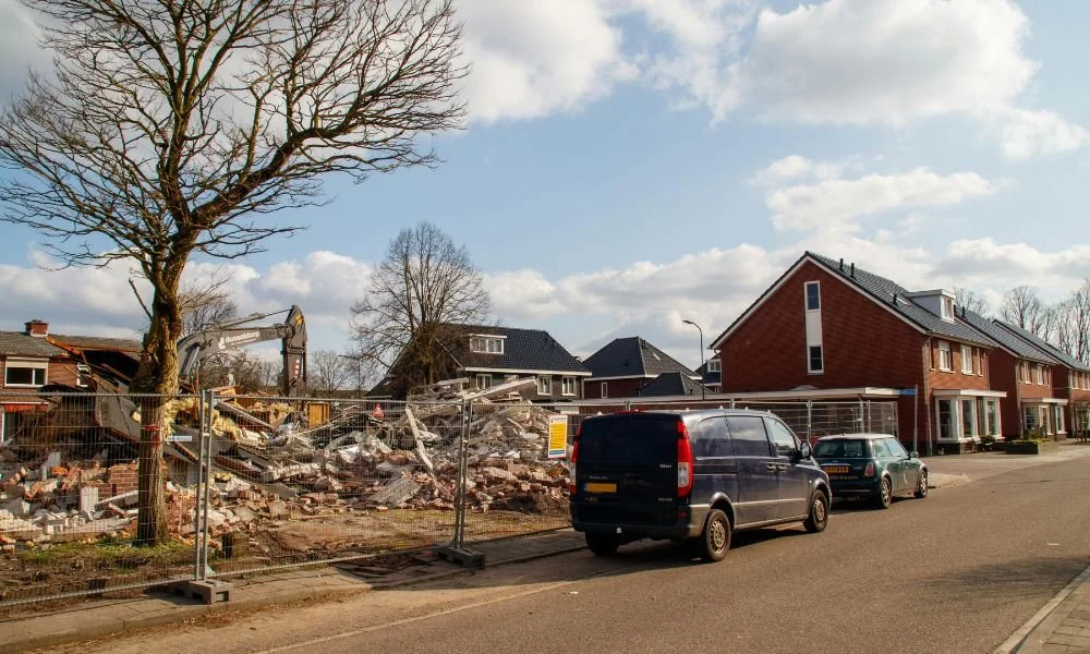 House being demolished by an excavator