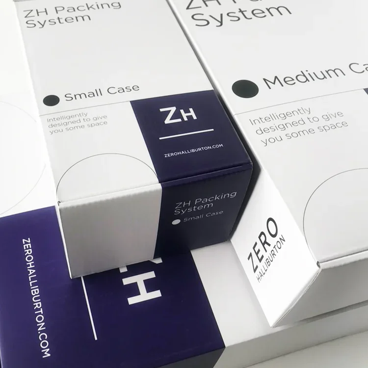 Three boxes of packing system containers, with one small case labeled 'ZH Zero Halliburton' and the website zerohalliburton.com visible.