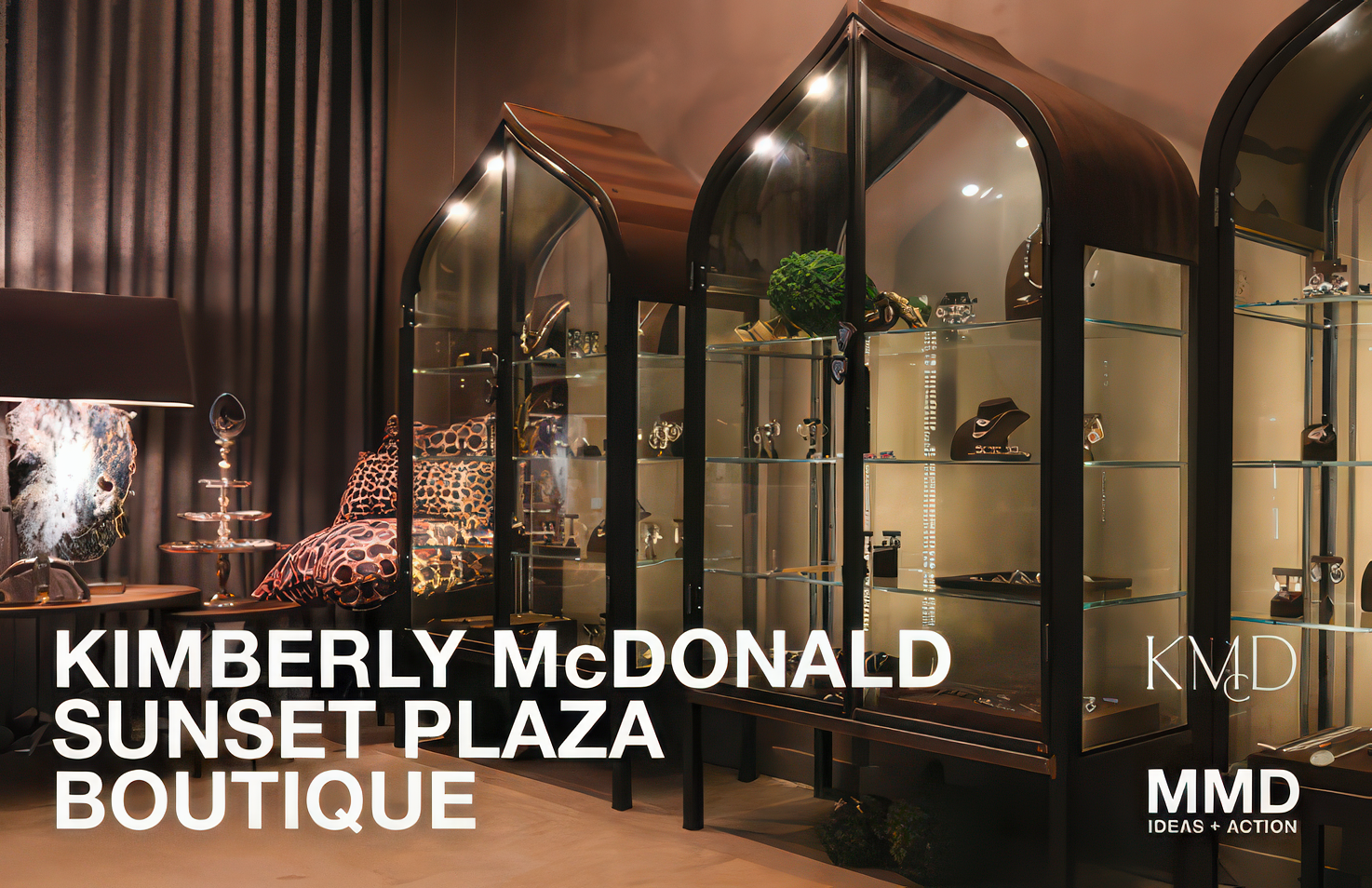 Interior of Kimberly McDonald Sunset Plaza Boutique displaying jewelry, accessories, and leopard print pillows with a dark curtain backdrop.