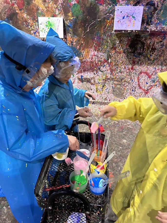 Children sharing tray of paints at SPLAT. Malta's paint-splatting art studio in Attard.