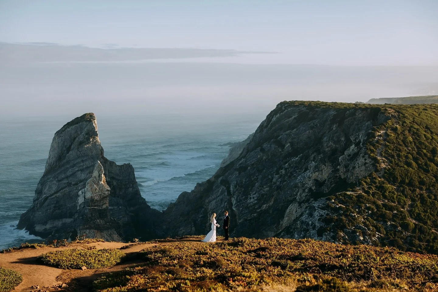 Megan &amp; Tom, just after sunrise in Portugal.

We hiked to Praia da Ursa before the sun was up, and by the time they shared their vows, the clouds had started to part. It was such a perfect, intimate moment full of so much love. 

More to come fro
