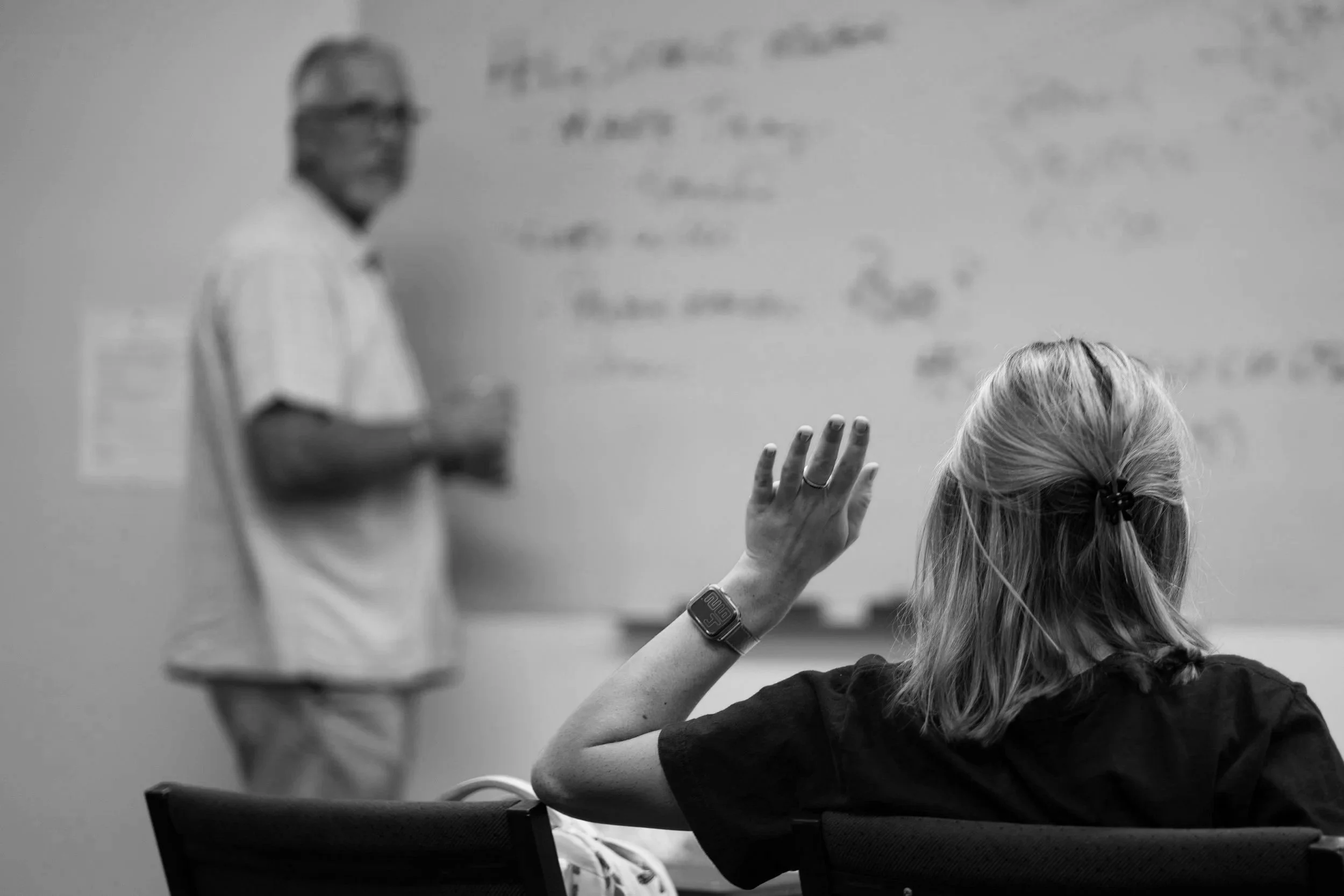 Woman raising hand in class