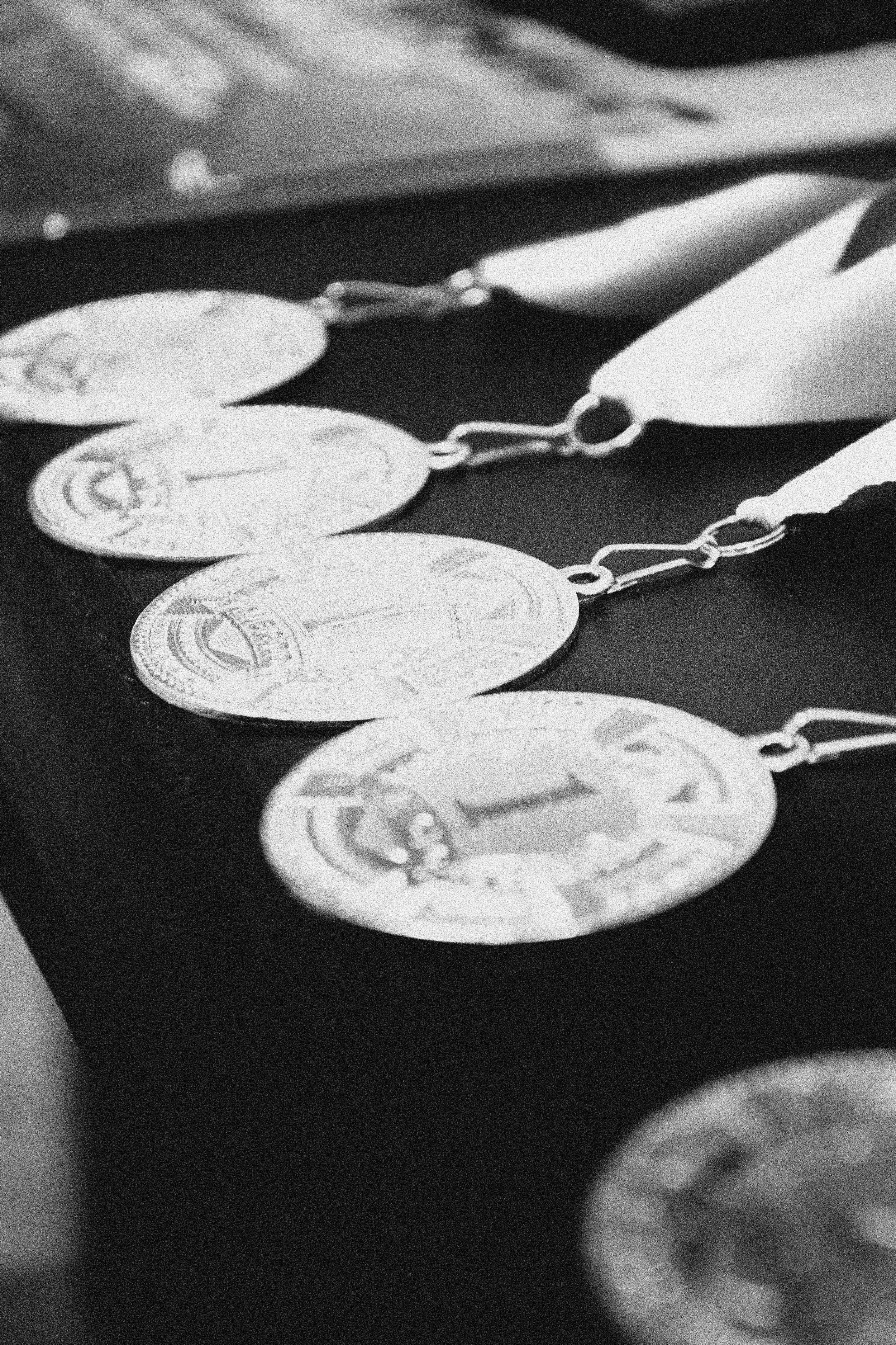 Close-up of medals with ribbons arranged on a dark surface.