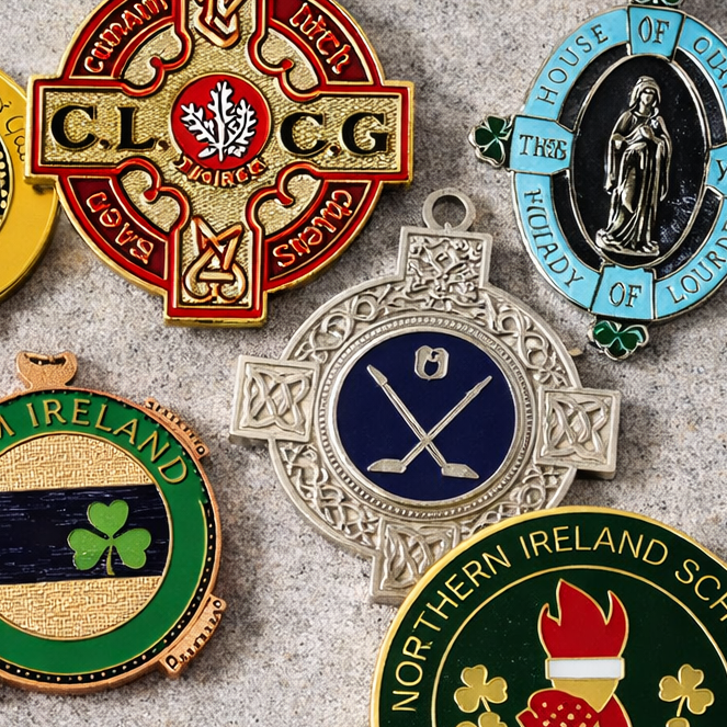 Collection of four Irish and Scottish-themed metal medals or badges with various designs and inscriptions.