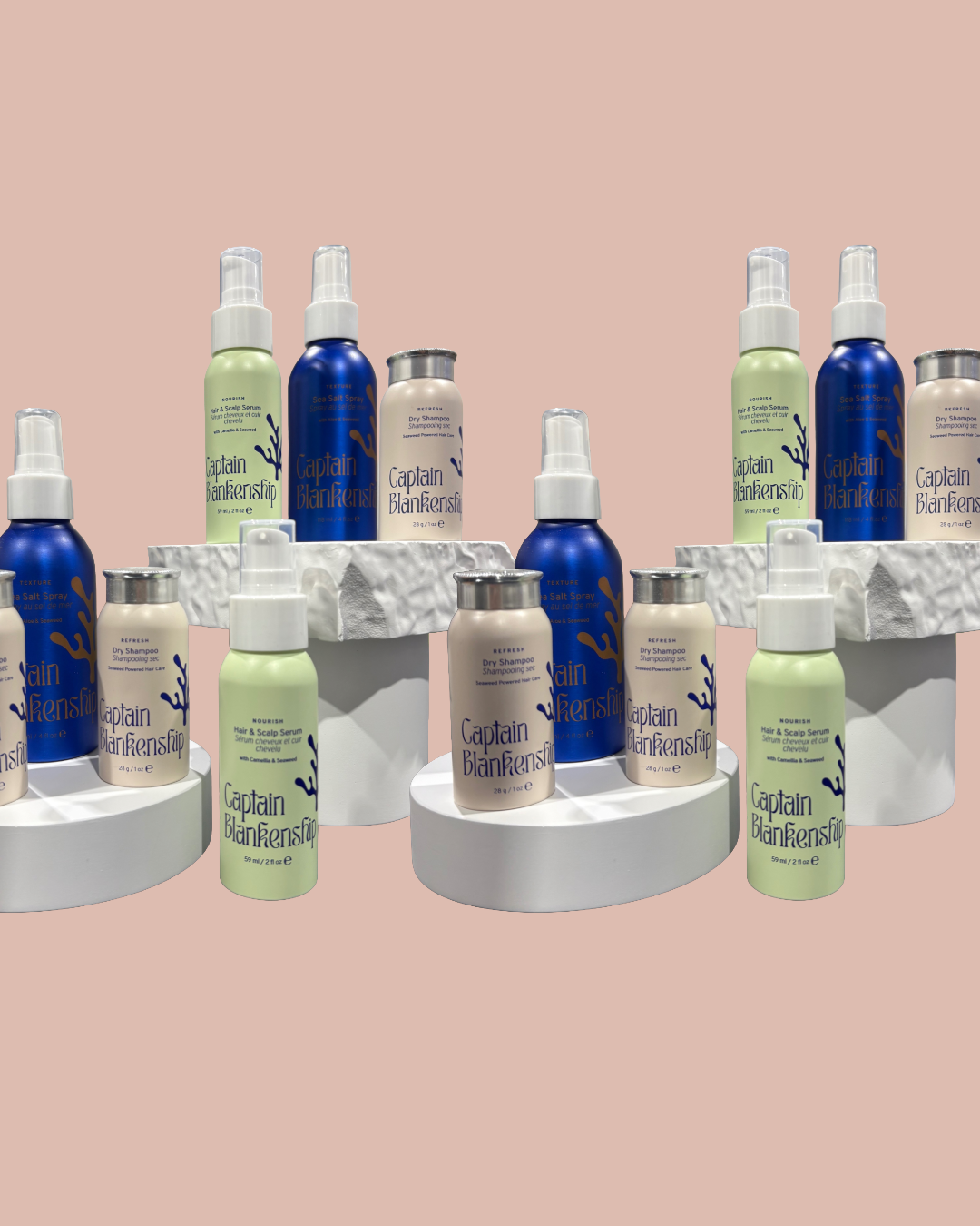 A modern building situated on a grassy hill with snow-capped mountains in the background.