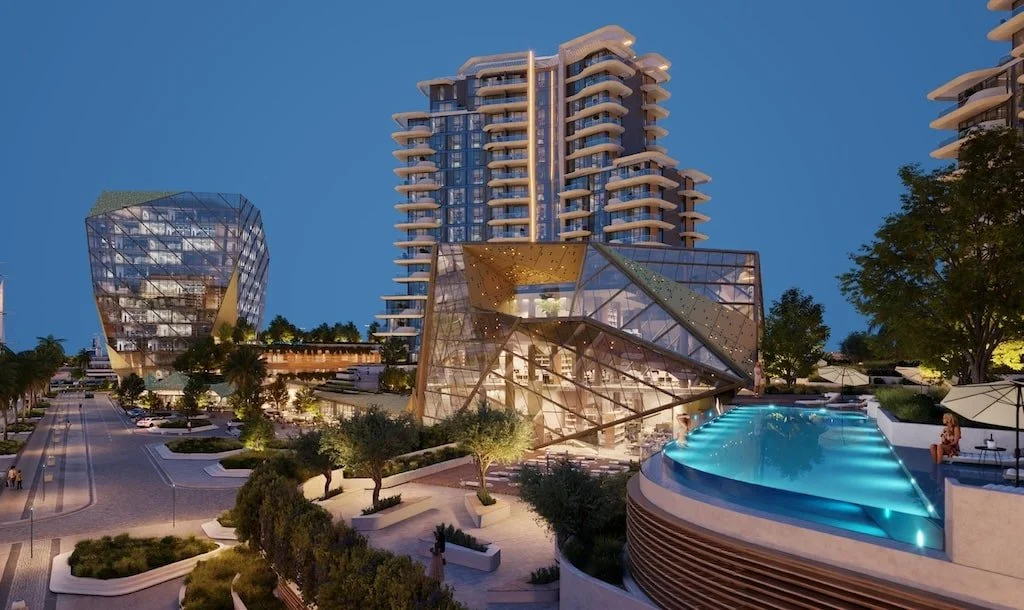 Modern multi-story building with balconies and greenery at sunset.