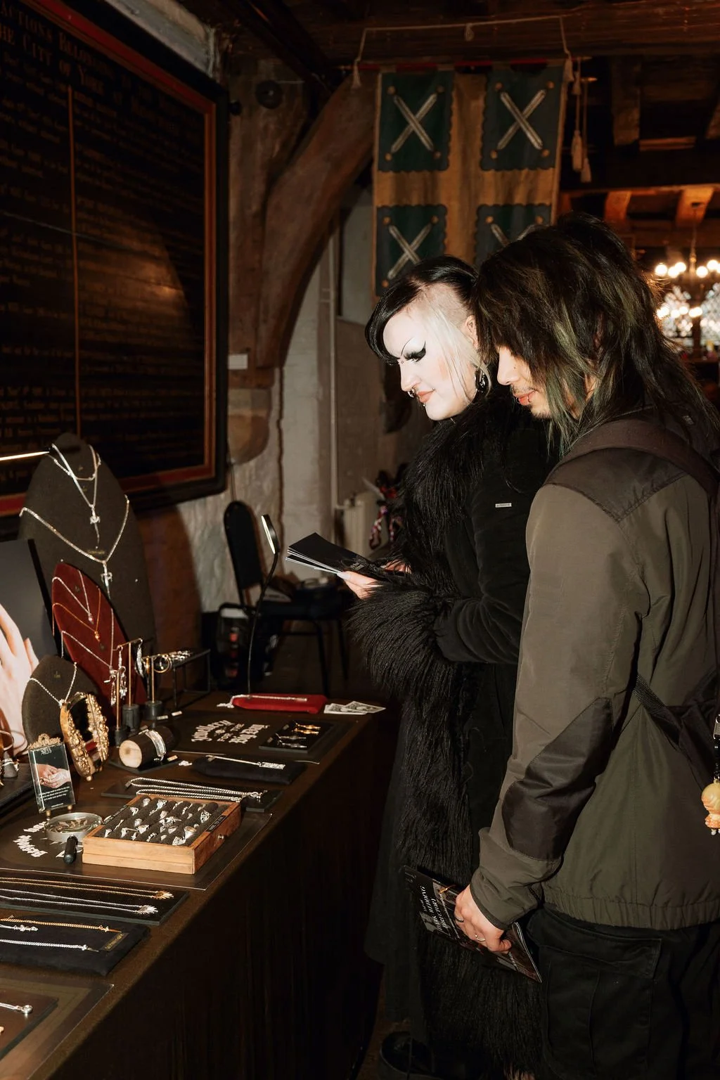 Dark wedding fair, couple looking at gothic wedding jewellery by SLAB jewellery
