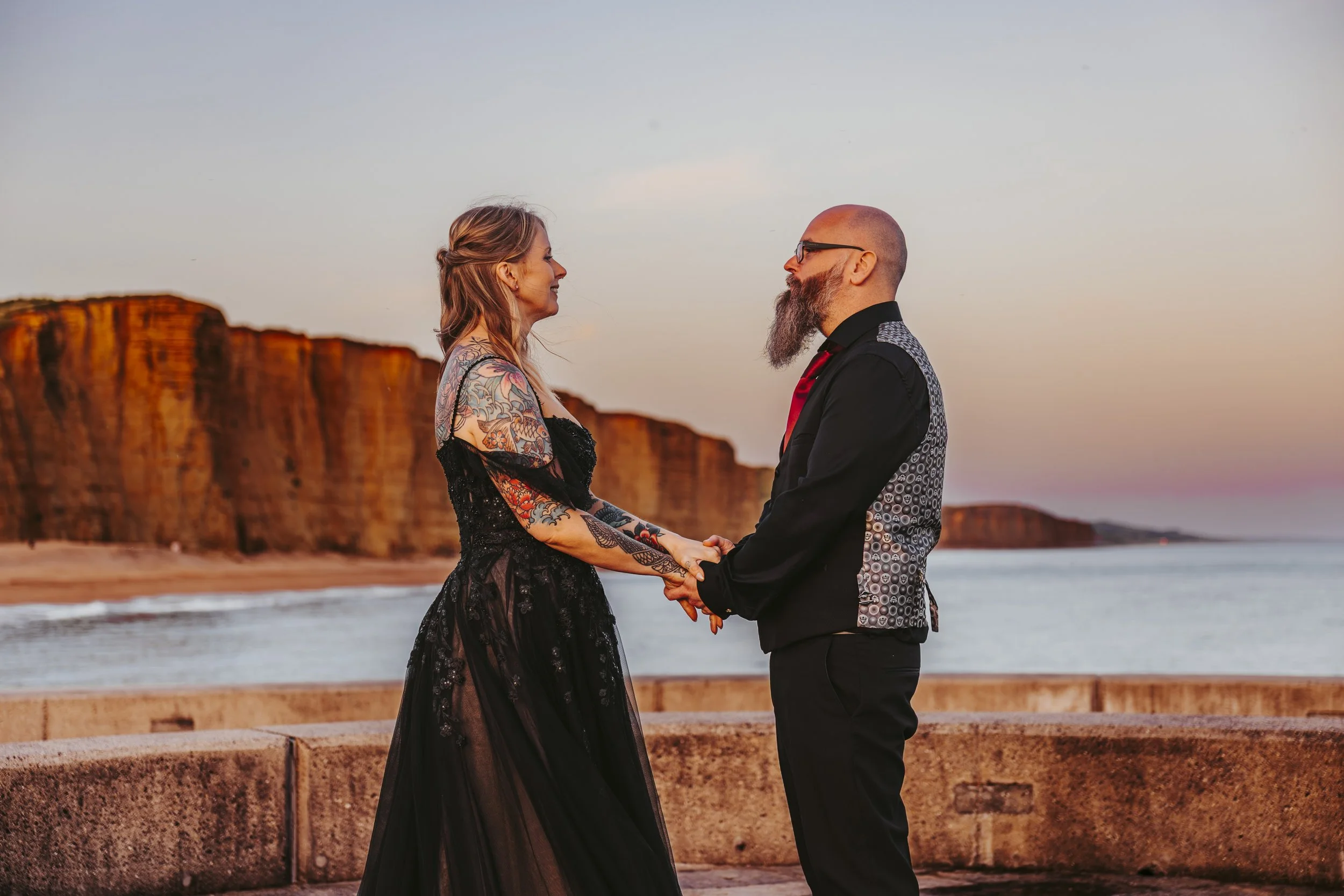 BurnTheScript-Couple-in-black-at-sunset-in-west-bay-dorset-alternative-wedding.jpg