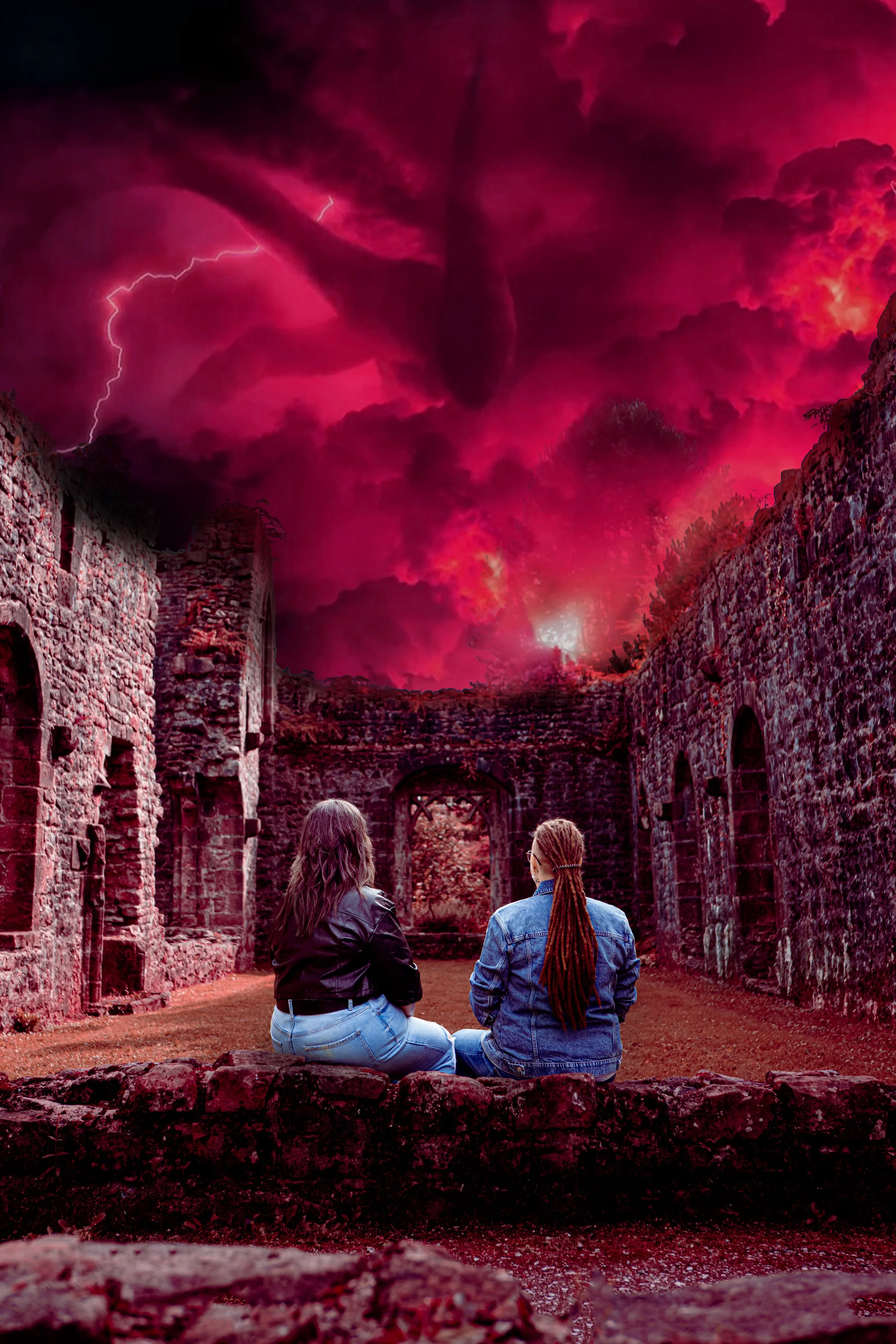 Two women sitting on a stone wall, facing an ancient stone ruin with a stormy sky overhead filled with dark pink and purple clouds, lightning, and a tornado.