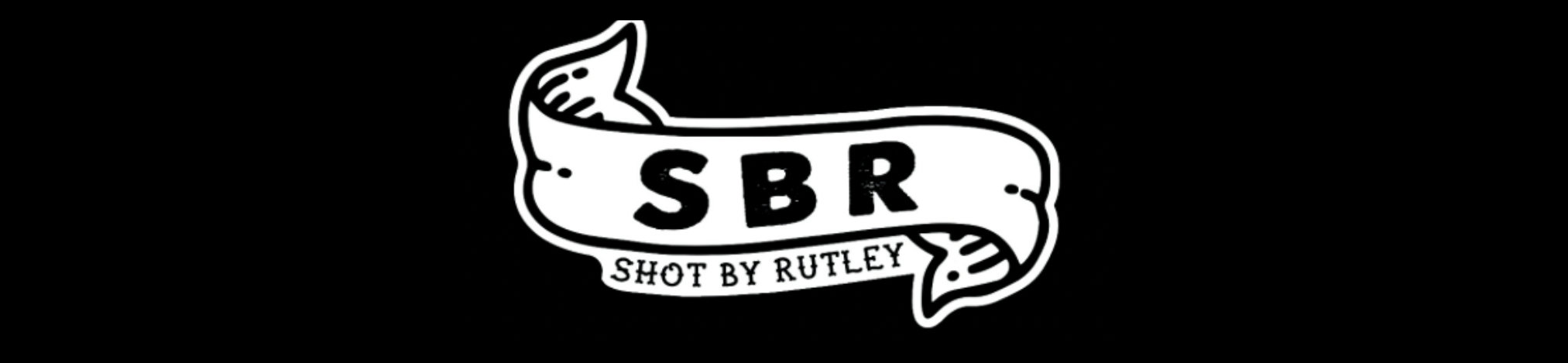 Black and white logo with the acronym 'SBR' on a banner and the text 'Shot by Rutley' below it.