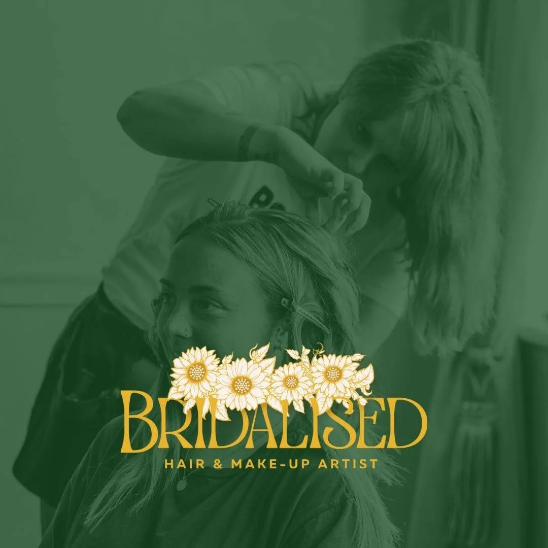 A woman getting her hair and makeup done by a beauty artist in a salon.