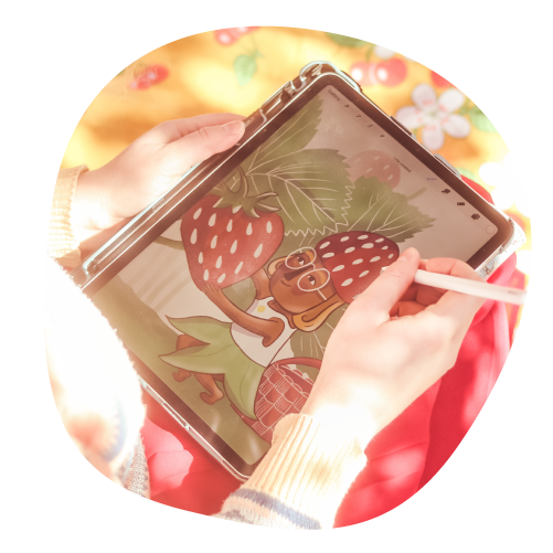 Ihminen piirtää mansikkalapsen kuvaa tabletilla.