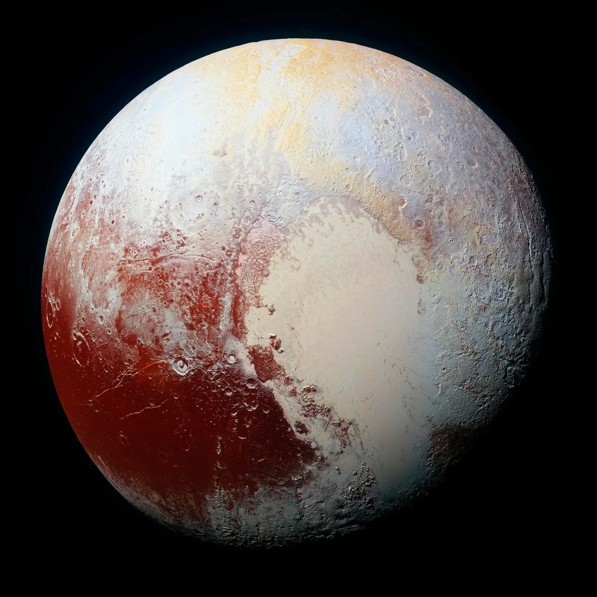 Close-up of Pluto's icy surface with reddish and white patches, craters, and rugged terrain.