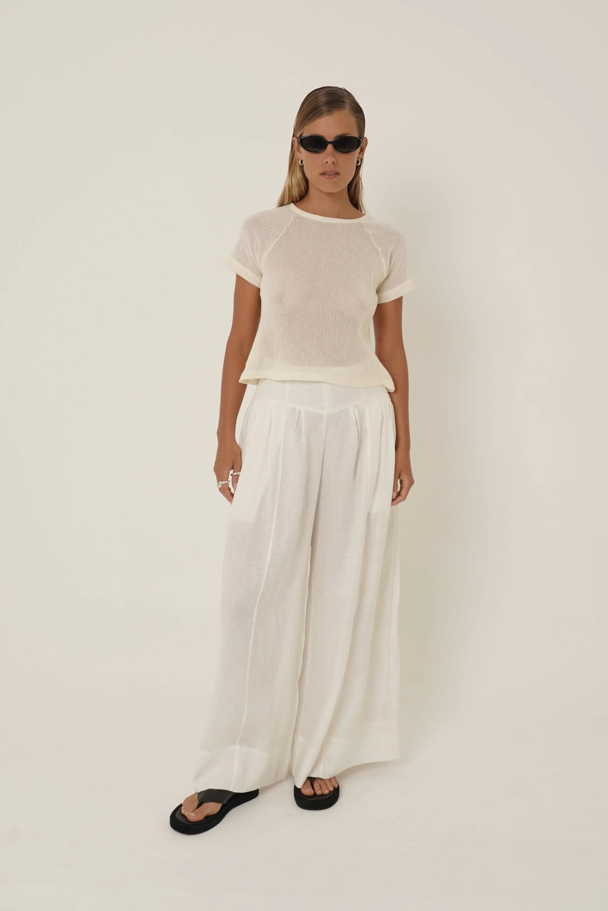 Woman wearing Breeze T-shirt and Cassandra Pants in white Linen