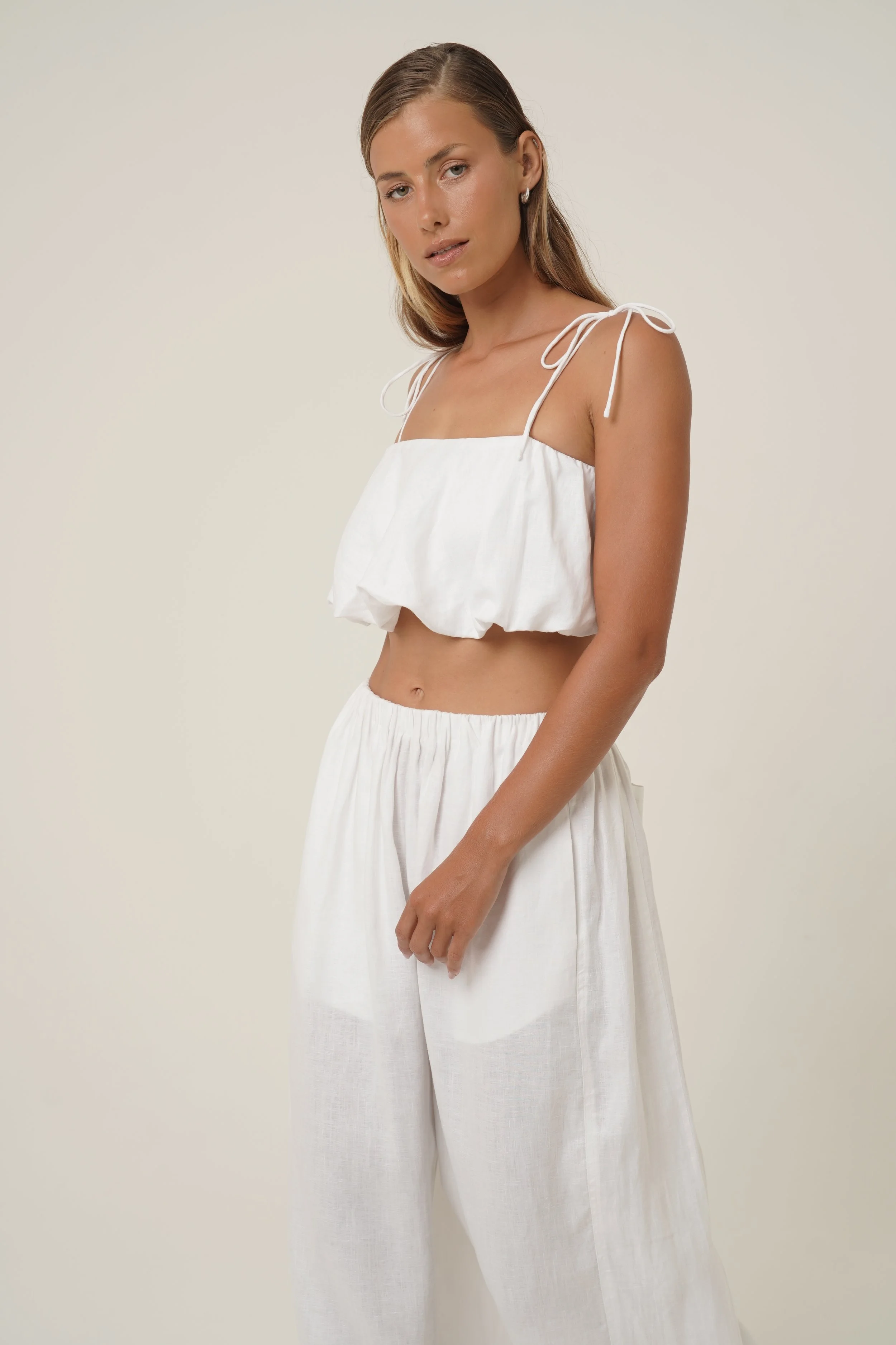 Woman wearing linen Crescendo Top with shoulder straps and double layer